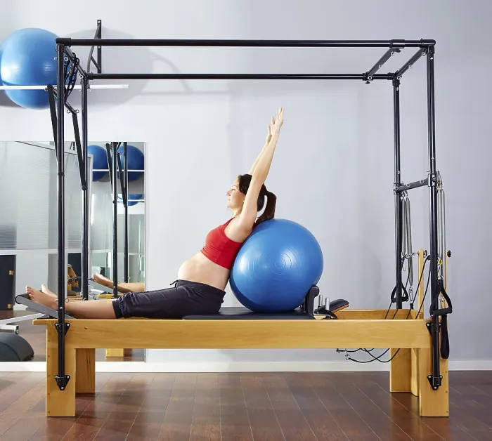 Framed Print : Pregnant woman pilates reformer fitball exercise workout at gym