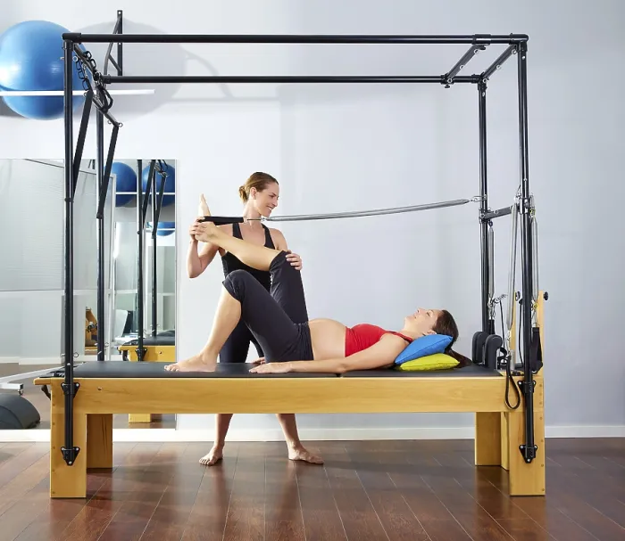 Framed Print : Pregnant woman pilates reformer leg spring exercise workout with personal trainer Framed Print : Pregnant woman pilates reformer leg spring exercise workout with personal trainer