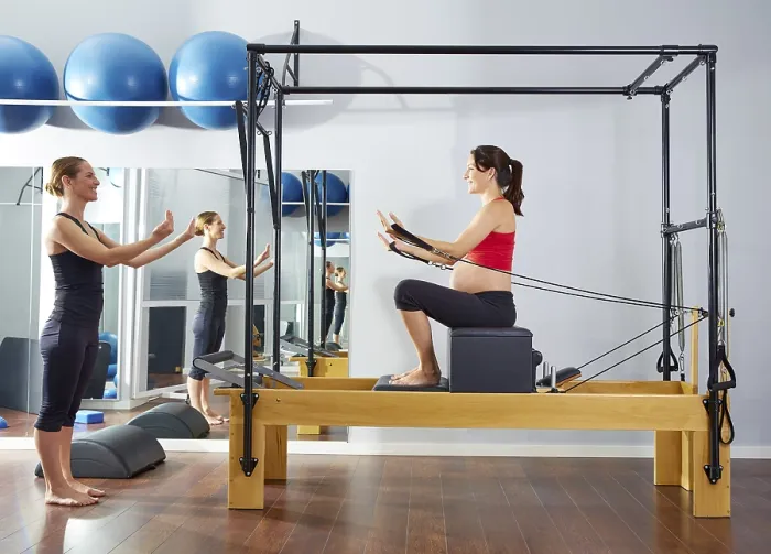 Framed Print : Pregnant woman pilates reformer short box exercise workout with personal trainer Framed Print : Pregnant woman pilates reformer short box exercise workout with personal trainer