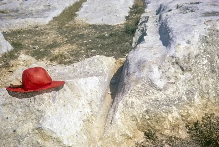 Framed Print : Prehistoric cart tracks crossing carboniferous limestone pavement, Malta, Europe 1971 red hat used for scale, Europe