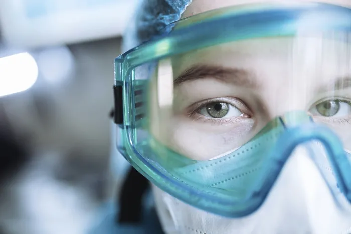 Framed Print : Professional in a clinical environment wearing a medical mask and goggles Framed Print : Professional in a clinical environment wearing a medical mask and goggles