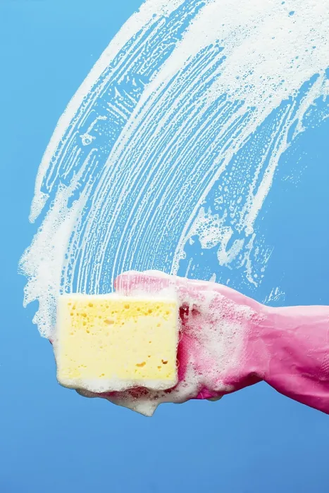 Framed Print : Professional window cleaner with sponge on blue background