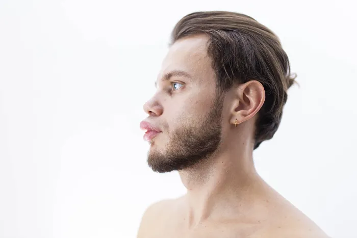 Framed Print : Profile view of a bearded person looking ahead against a white background