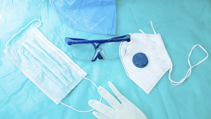 Framed Print : Protective gear spread on blue surface including a mask