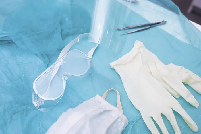 Framed Print : Protective glasses and mask with gloves on a teal background