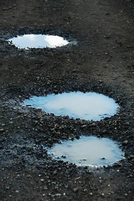Framed Print : Three puddles on a gravel path mirror the overcast sky