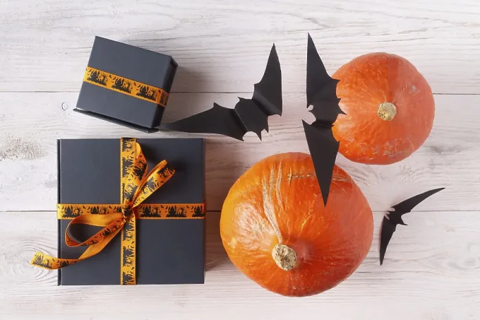 Framed Print : Pumpkin gifts black paper bats on light wood flat lay halloween decor