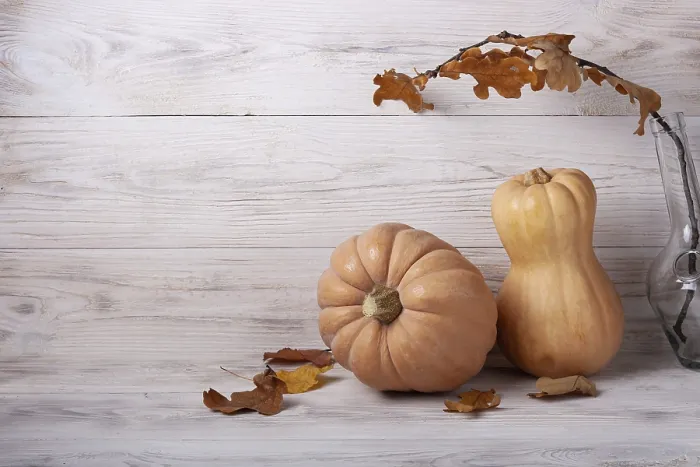 Framed Print : Pumpkins and autumn leaves on white wooden background