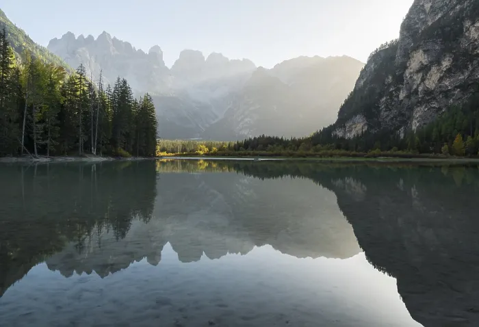 Framed Print : A quiet lake (Toblach lake) reflects the surrounding mountains in the soft evening light