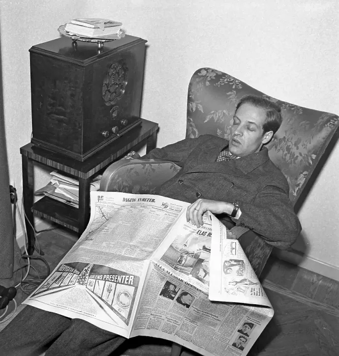 Framed Print : Radio listener in the 1940s. A man manages to fall asleep while reading the paper and listening to the radio. 1944. Kristoffersson ref L180-2
