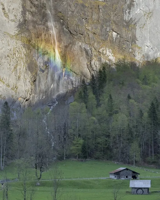 Framed Print : Rainbow-lit Waterfall Cascading Down Rocky Cliff Above Alpine Meadow in the Swiss Alps Framed Print : Rainbow-lit Waterfall Cascading Down Rocky Cliff Above Alpine Meadow in the Swiss Alps