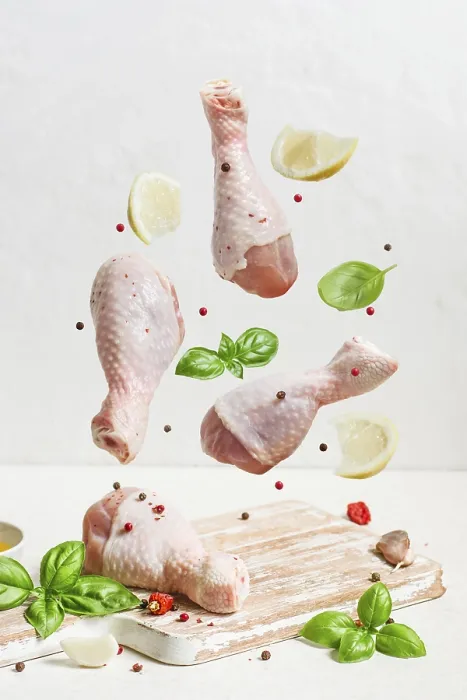Framed Print : Raw chicken drumstick And spices fly over the cutting board