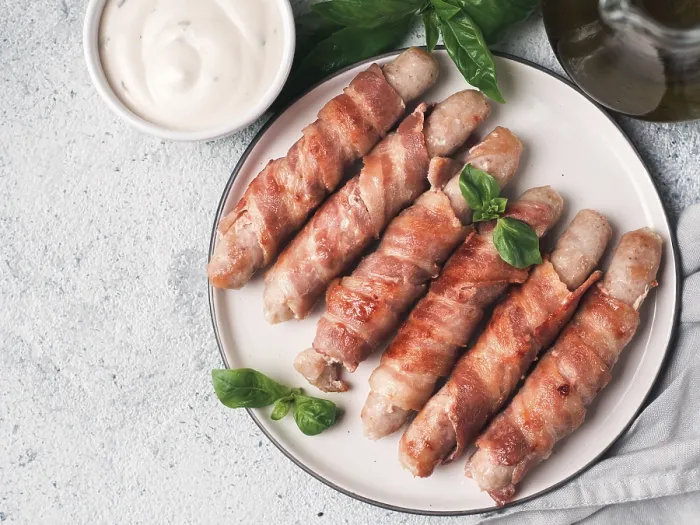 Framed Print : Ready-to-eat pigs sausages wrapped in bacon on plate Framed Print : Ready-to-eat pigs sausages wrapped in bacon on plate