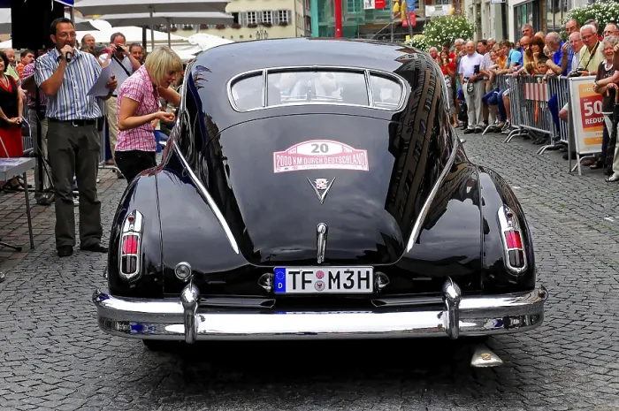 Framed Print : Rear view of a black classic car surrounded by crowds Framed Print : Rear view of a black classic car surrounded by crowds