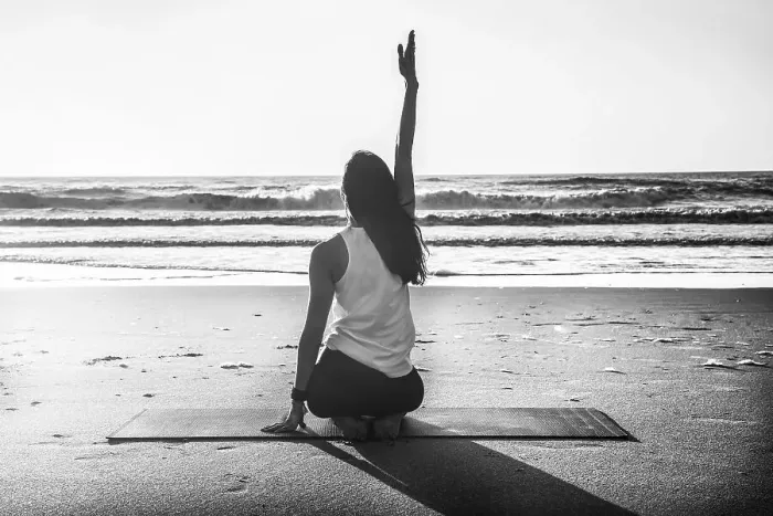 Framed Print : Rearview shot of a young woman practicing yoga at the beach Framed Print : Rearview shot of a young woman practicing yoga at the beach