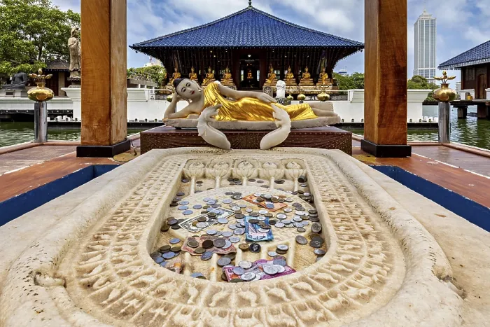 Framed Print : Reclining Buddha statue in a temple with coins in the foreground