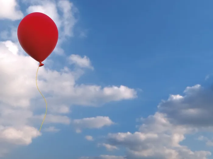 Framed Print : Red balloon against blue sky with clouds