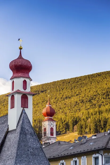 Framed Print : Red bell towers of the church of a mountain village in Italy Framed Print : Red bell towers of the church of a mountain village in Italy