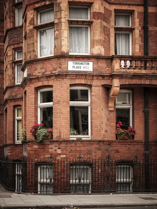 Framed Print : Red brick building with flower boxes on windows in the city in Greater London