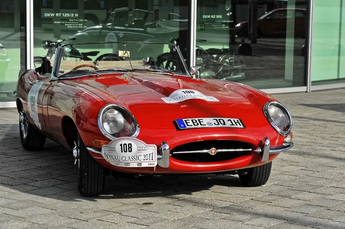 Framed Print : A red classic convertible classic car stands on a paved square Framed Print : A red classic convertible classic car stands on a paved square