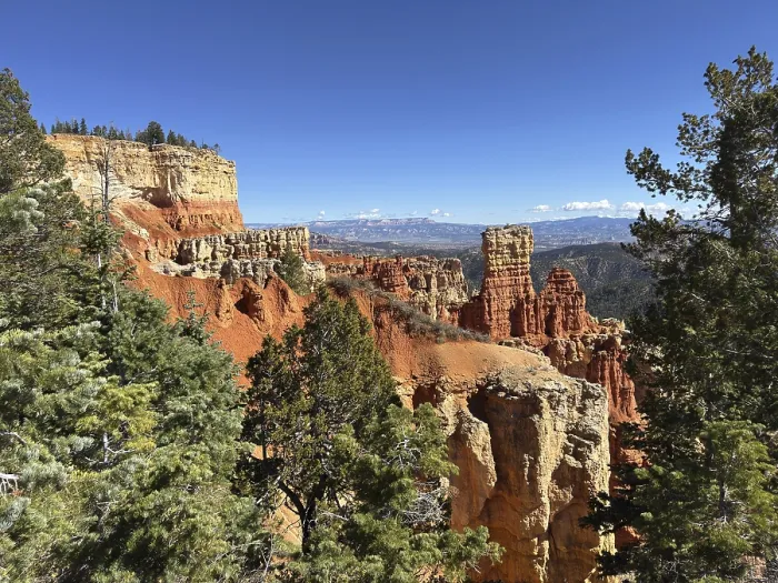 Framed Print : Red cliffs and thick forests stretch to the horizon under deep blue skies