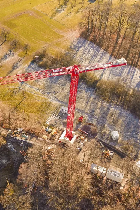 Framed Print : Red crane seen from the air on a construction site on the edge of a forest in an autumn landscape
