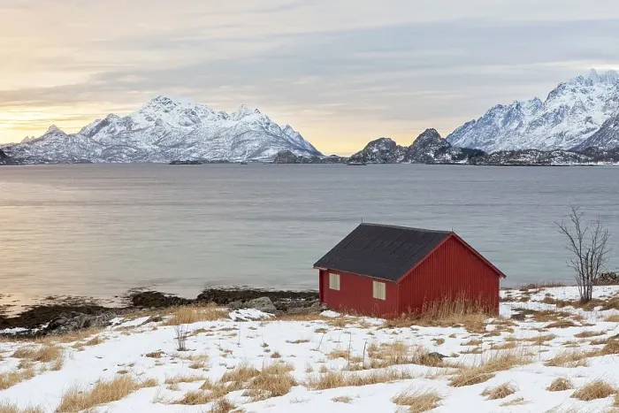 Framed Print : Red house at a fjord in winter