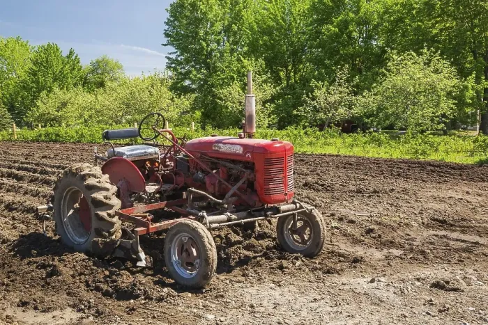 Framed Print : Red McGormick Farmall Super A tractor in plowed agricultural field