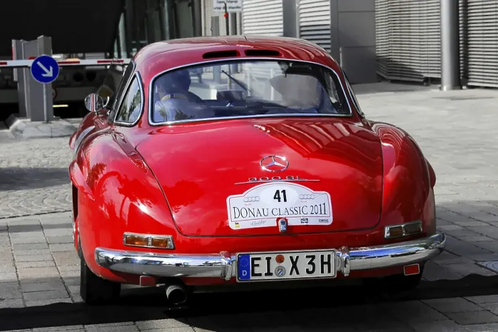 Framed Print : Red Mercedes classic car with Donau Classic 2011 license plate in urban area