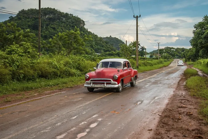 Framed Print : Red old american car drive on rural road in Cuban mountains Framed Print : Red old american car drive on rural road in Cuban mountains