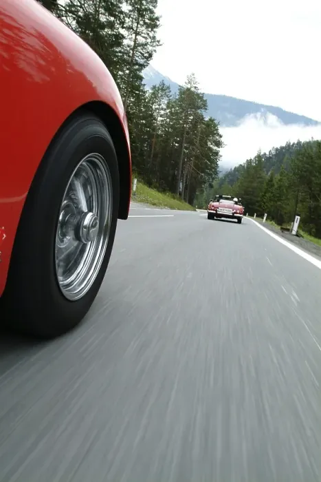 Framed Print : Red TR 3 driving behind a red vintage car
