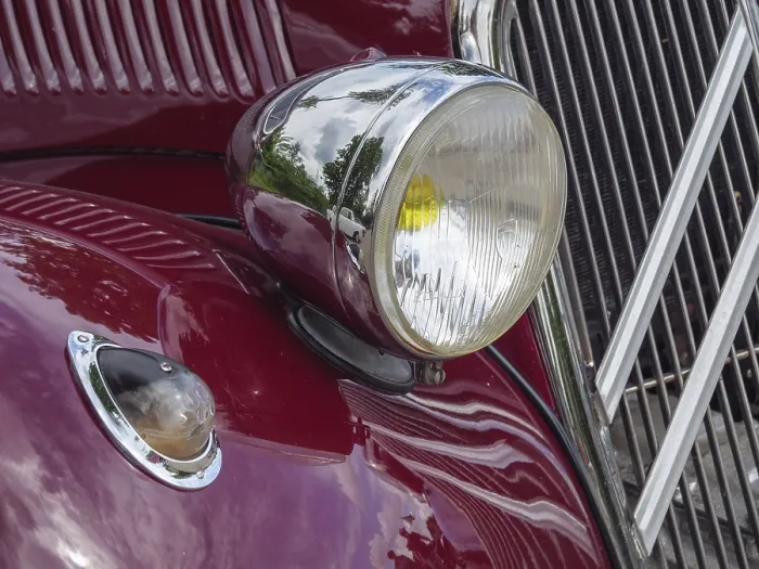 Framed Print : Red vintage car with round chrome headlights and chrome-plated details