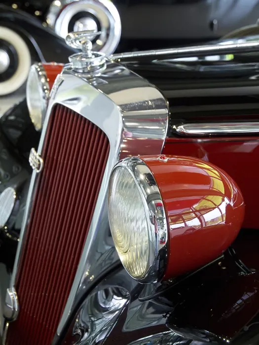 Framed Print : Red vintage car with round headlights and retro-style chrome details