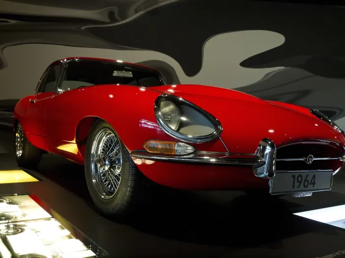 Framed Print : Red vintage car from the front view in an exhibition