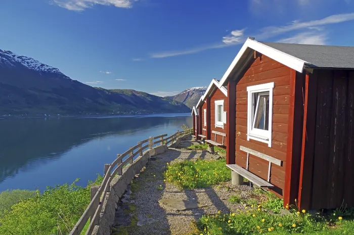 Framed Print : Red wooden cabins on a campsite