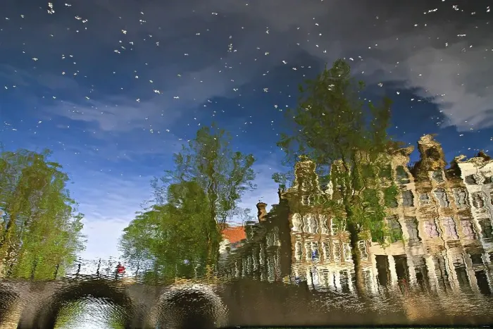 Framed Print : Reflection of buildings in a canal in Amsterdam