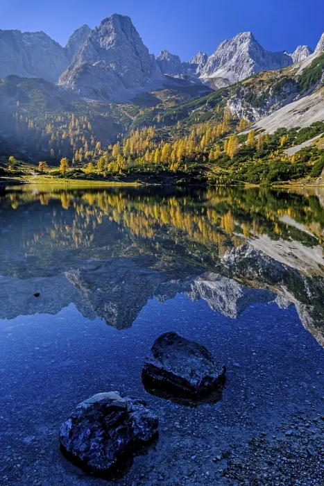 Framed Print : Reflection of steep mountains in a mountain lake