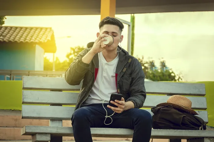 Framed Print : Relaxed attractive boy listening to music on a bench Framed Print : Relaxed attractive boy listening to music on a bench