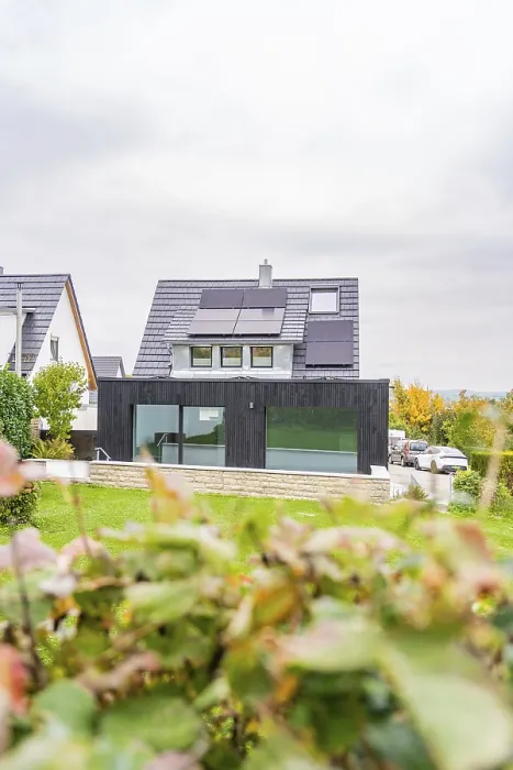 Framed Print : Residential building with black extension and glass front between neighboring houses