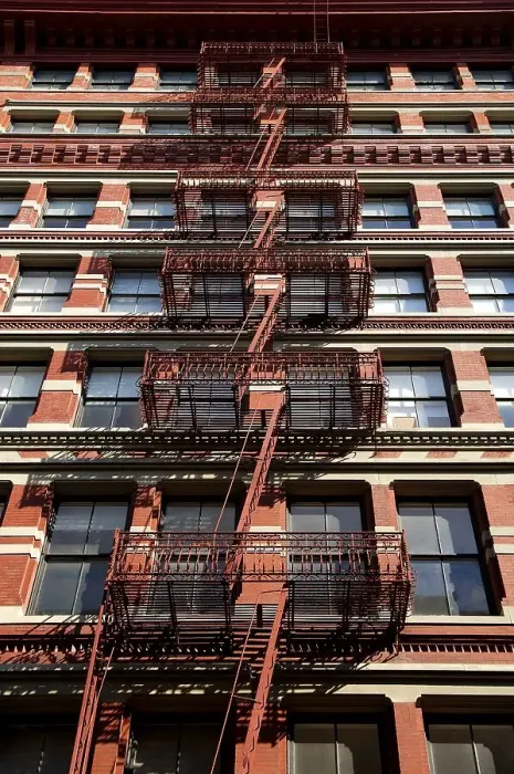 Framed Print : Residential housing facade with fire escape ladders