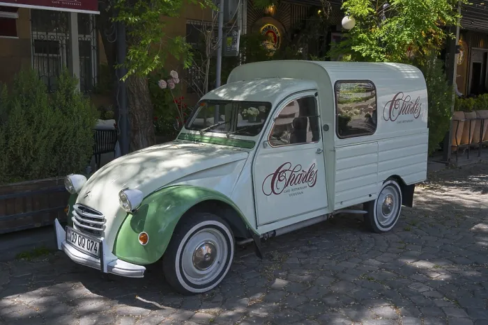 Framed Print : Retro-colored Citroen car parked in shady area under trees