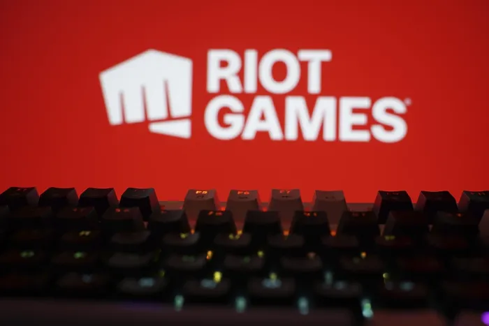 Framed Print : Riot Games logo with a backlit keyboard on a vibrant red background Framed Print : Riot Games logo with a backlit keyboard on a vibrant red background