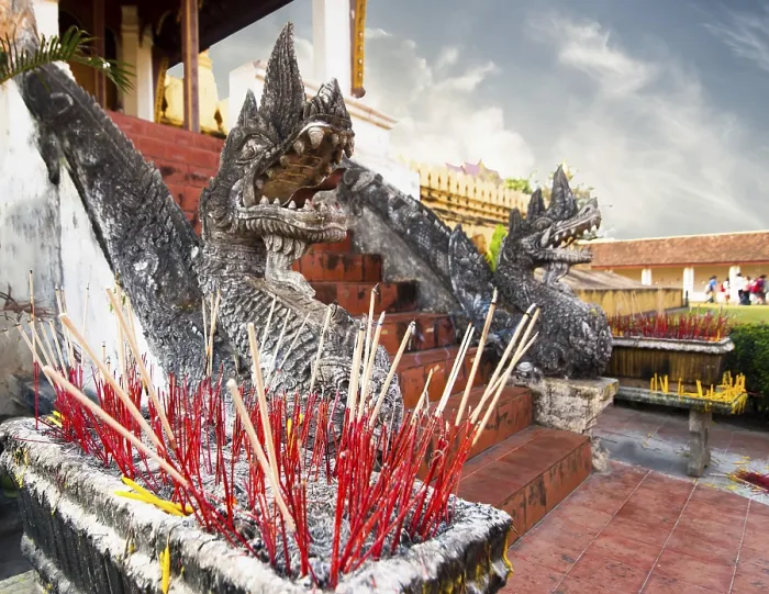 Framed Print : Ritual smoke of aroma sticks at Golden buddhist pagoda Phra That Luang Temple