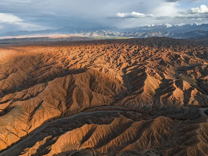 Framed Print : River bed runs through a landscape of eroded hills