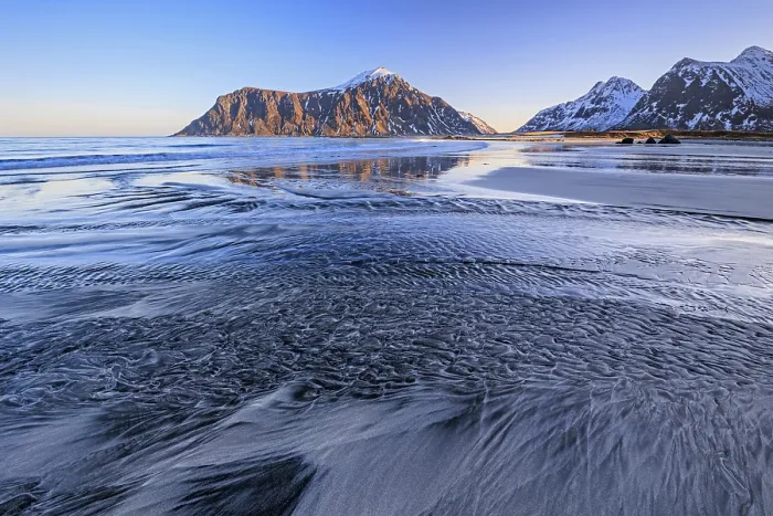Framed Print : River course on the beach in front of snowy mountains Framed Print : River course on the beach in front of snowy mountains