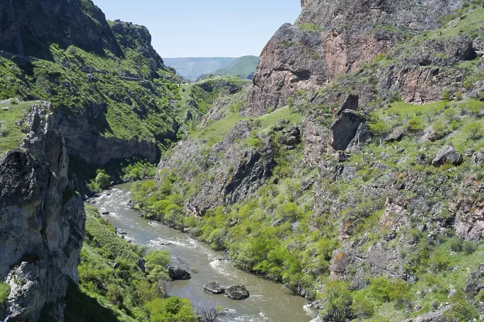 Framed Print : A river flows through a narrow green gorge with steep rocky slopes Framed Print : A river flows through a narrow green gorge with steep rocky slopes