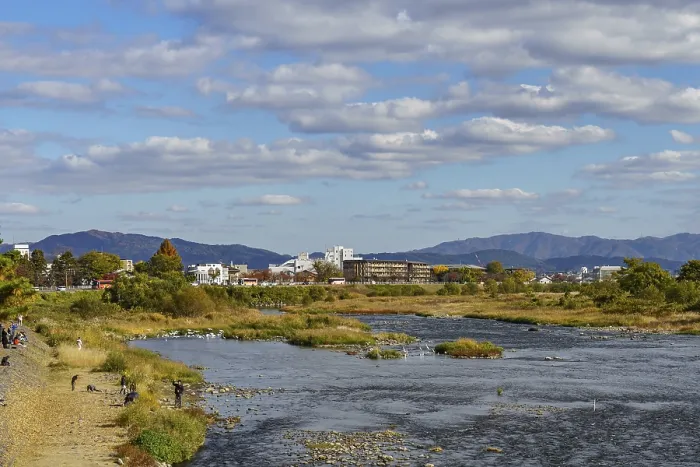 Framed Print : A river landscape with an urban background and picturesque mountains Framed Print : A river landscape with an urban background and picturesque mountains
