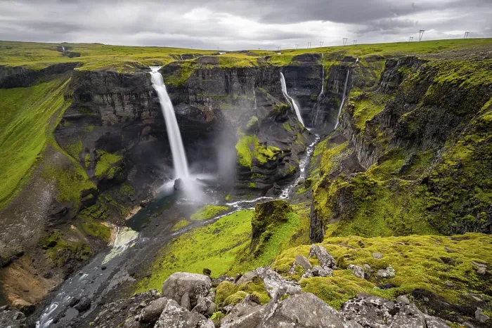 Framed Print : River and waterfalls at a canyon with green moss