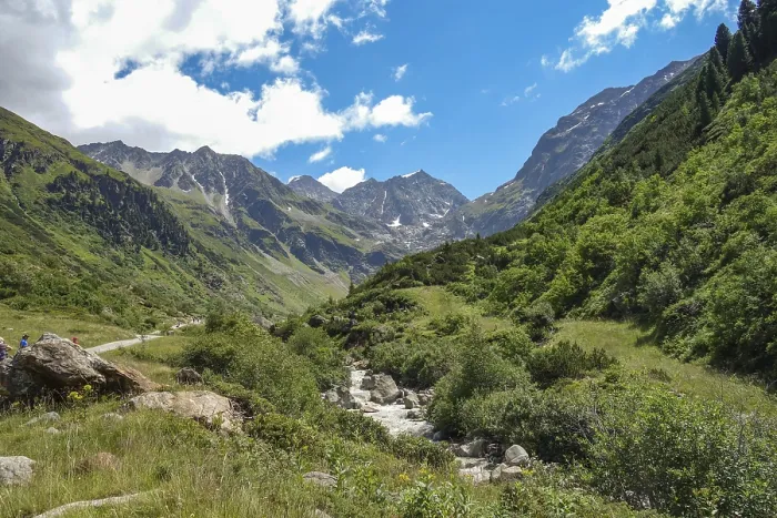 Framed Print : A river winds through a green valley between high mountains