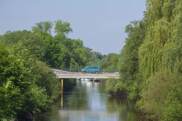 Framed Print : Road bridge with delivery van over the river Wumme in spring
